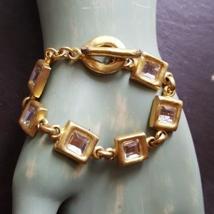 Heavy gold metal and glass bracelet.